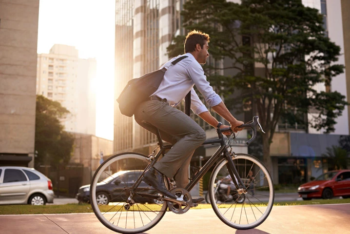 man cycling through city