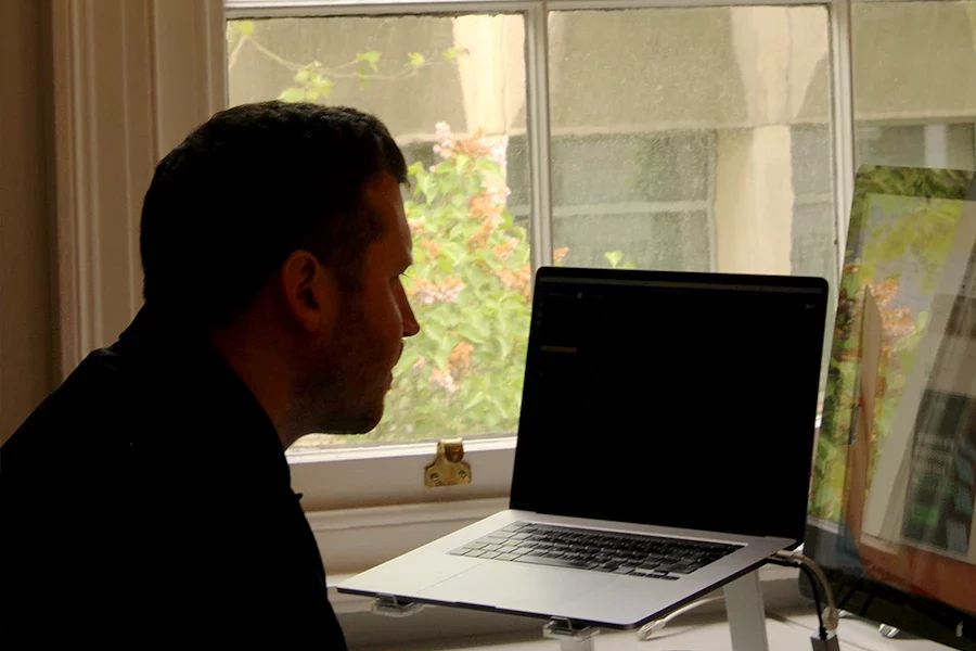 Silhouette of Design Director Lee working at desk