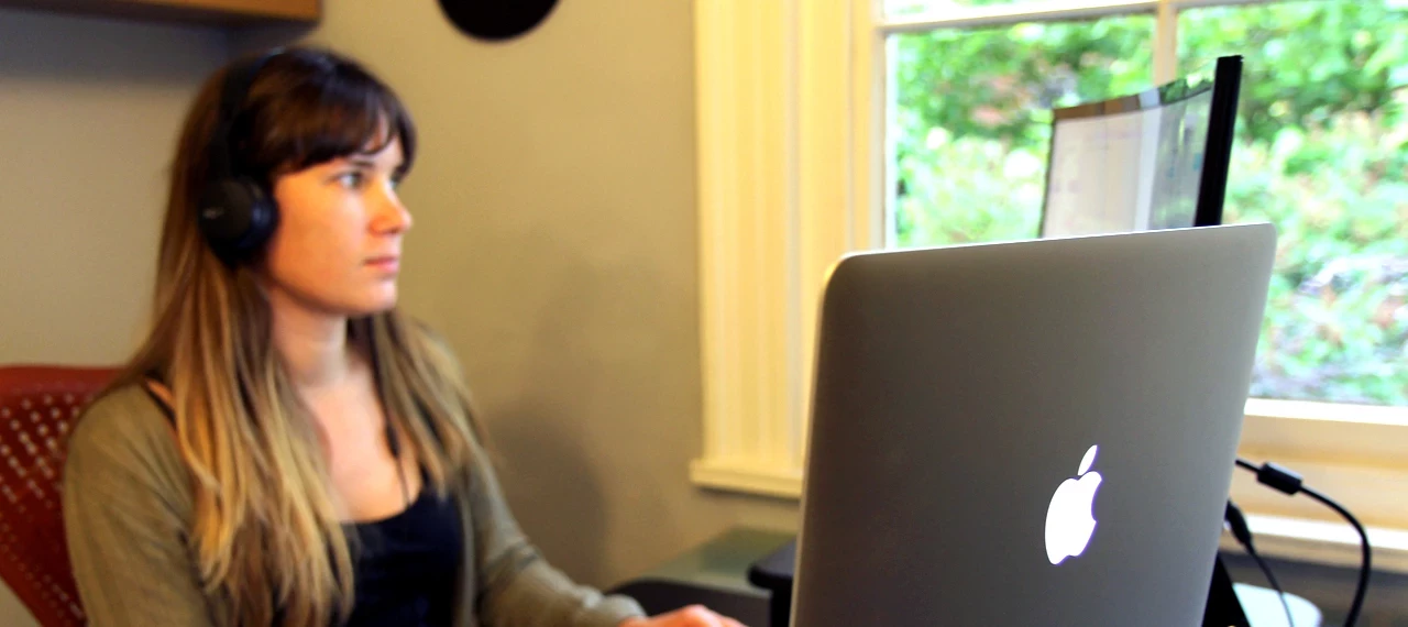 Jenny sat at her desk with headphones on