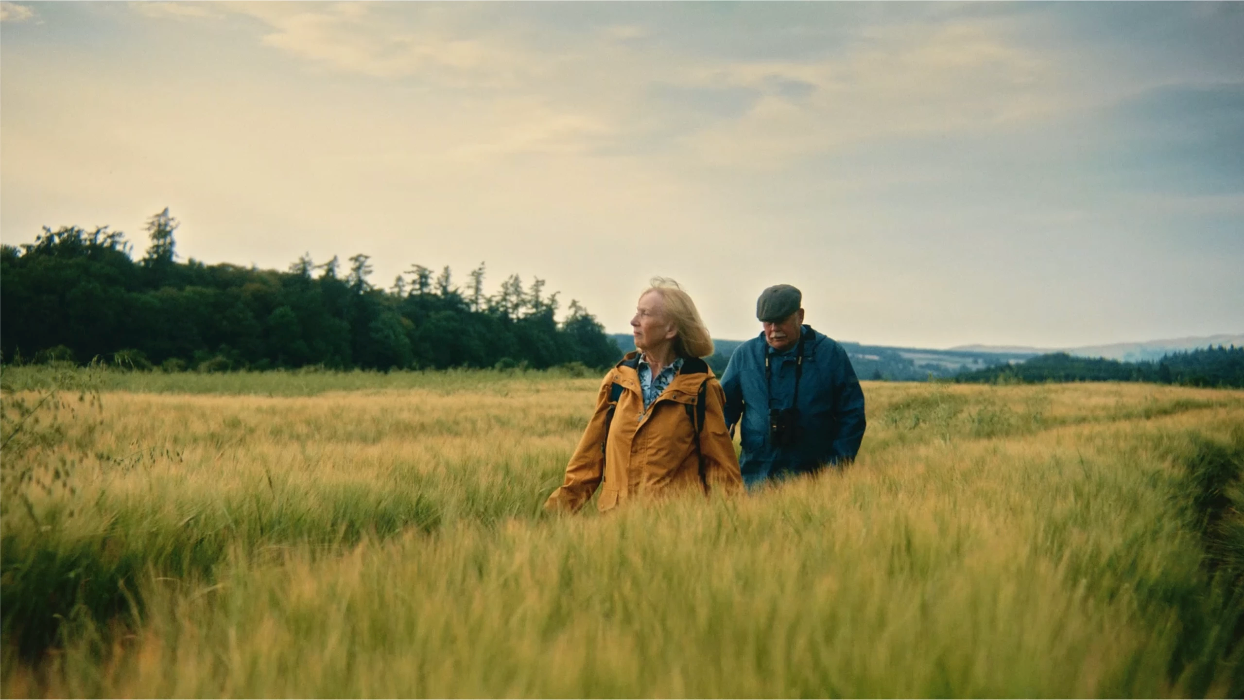 two people walking through a field in Scotland